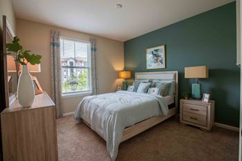 A bedroom with a bed and a window